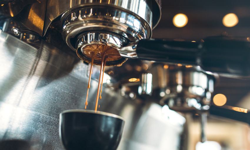 close up shot of espresso machine dispensing coffee
