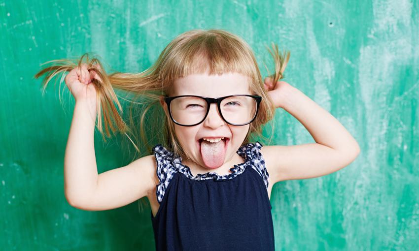 little girl with glasses tugging on her hair