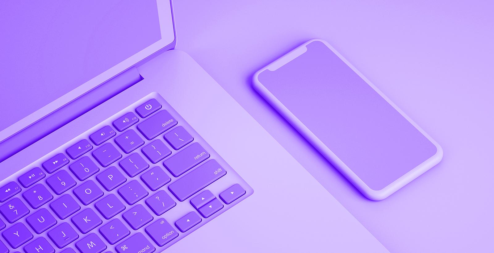 Laptop and smartphone on a desk, both in monochrome purple.