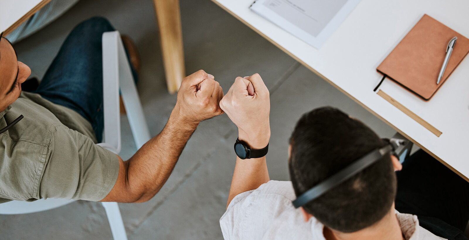Two colleagues bumping fists