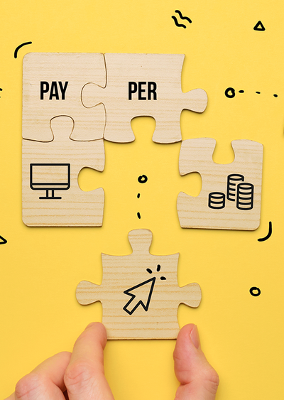 Hands putting together puzzle pieces that say "pay-per-click"