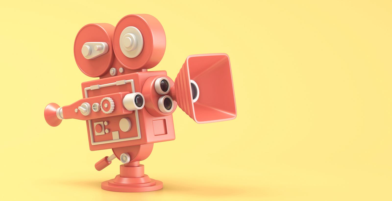 Red movie camera on yellow background.
