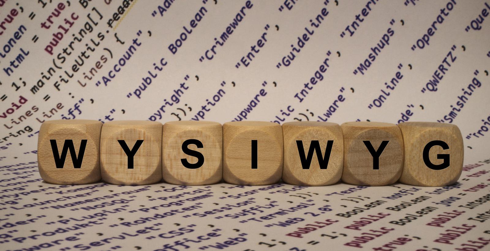 WYSIWYG on Wooden Dice with internet terms printed on paper