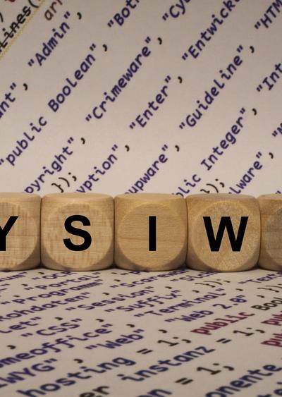 WYSIWYG on Wooden Dice with internet terms printed on paper