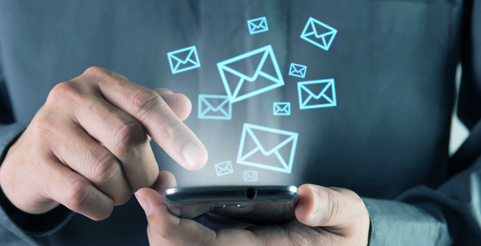 Man on Phone with email icons floating up
